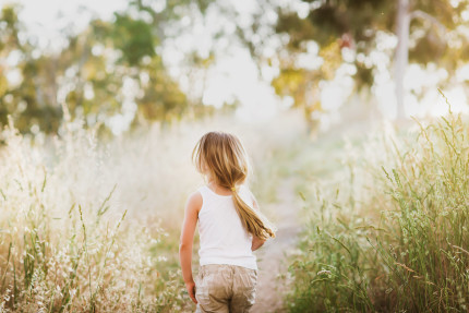 Sydney photographer: Girl walking in field by Cindy Cavanagh