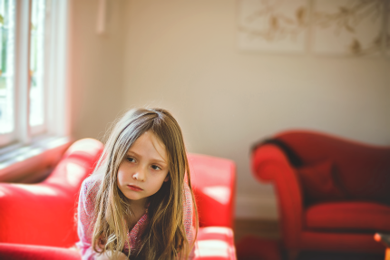 Lifestyle photography Sydney: Girl sitting on red sofa