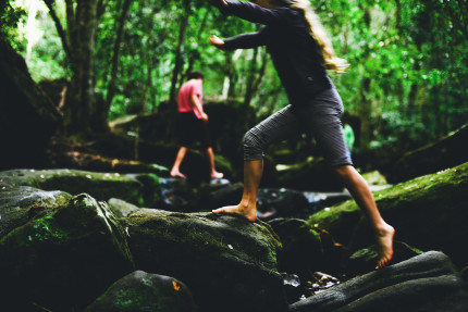 photographers sydney- girl jumping over rocks.