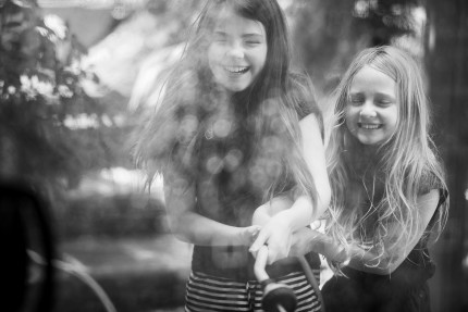 family photography sydney - girls playing with hose